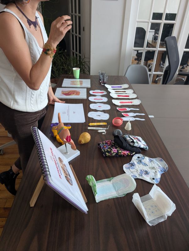 Menstrual products and anatomy models laid out for a hands-on workshop